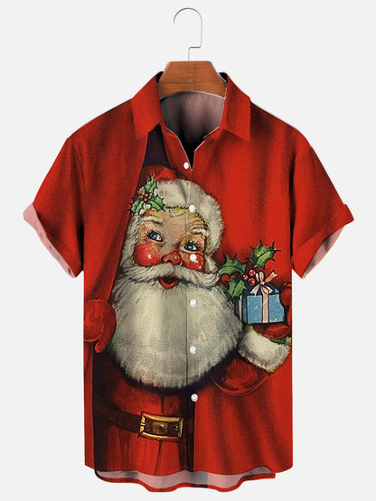 Santa Claus behind curtain holding small gift graphic printed holiday short sleeve shirt